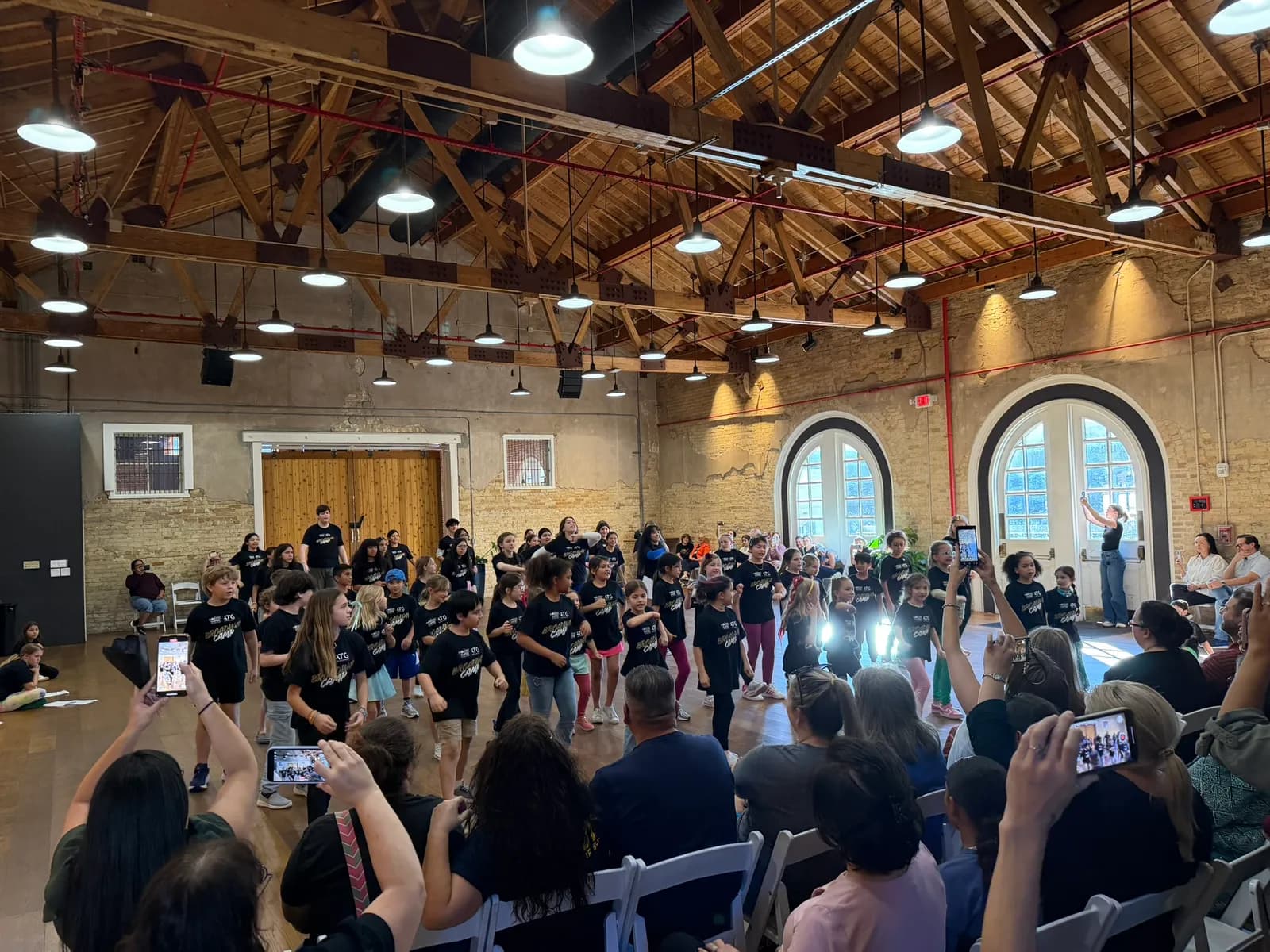 Campers performing while the audience films