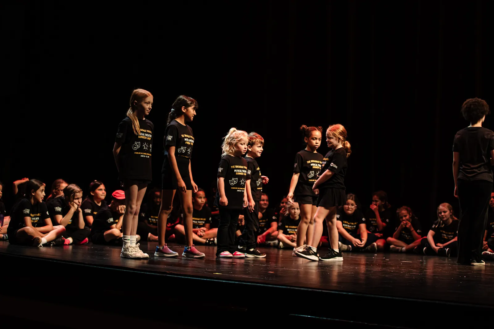 A small group of campers performing a scene onstage